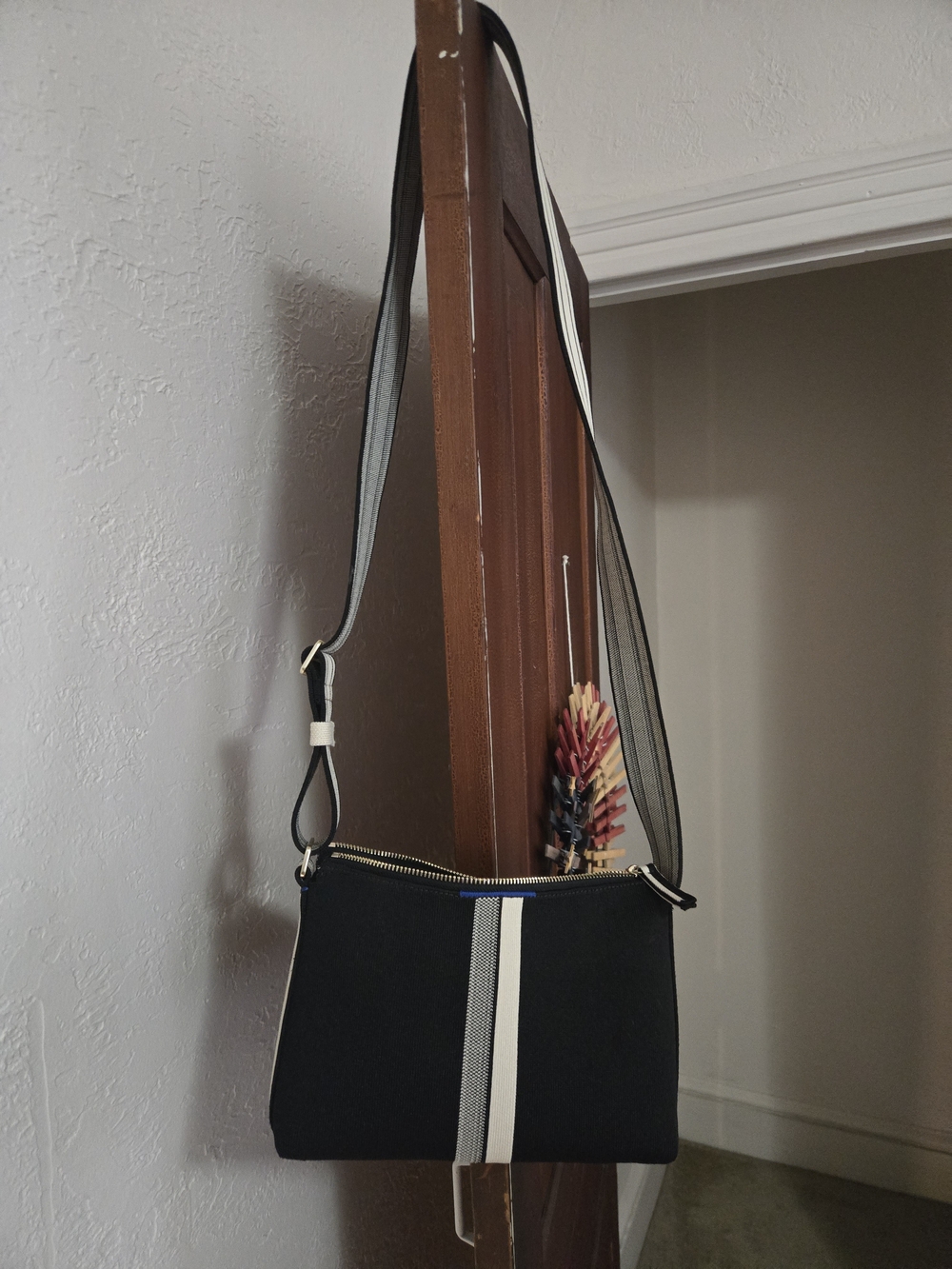 Rothy's Black Crossbody with Center Gray-White Stripe and Gold Zipper